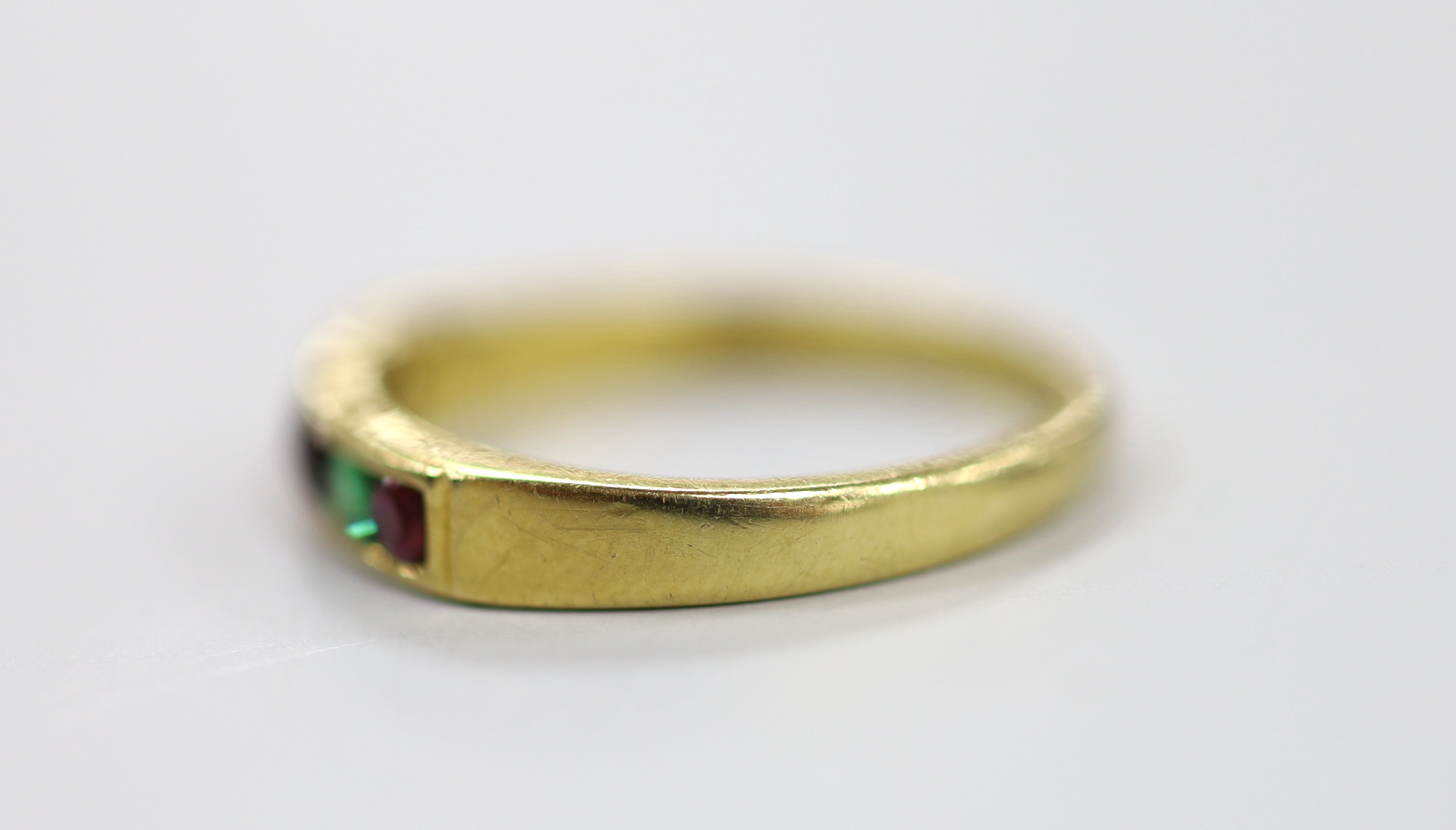 A modern 18ct gold and gem set half hoop 'Regard' ring, size L/M, gross weight 2.7 grams.